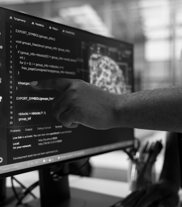 IT expert pointing to PC monitor, using machine learning to optimize server farm